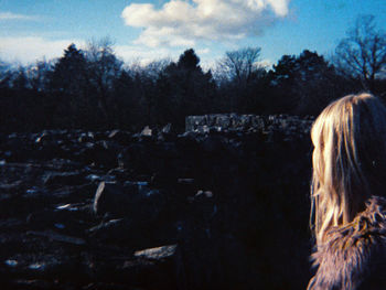 Rear view of woman on landscape against sky