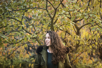 Portrait of a smiling young woman standing outdoors