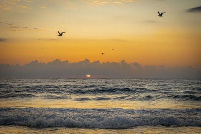 Scenic view of sea against sky during sunset