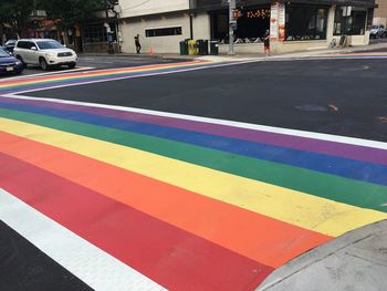 Multi colored zebra crossing on road in city