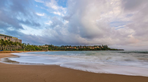 View of beach against cloudy sky