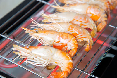 High angle view of fish on barbecue grill