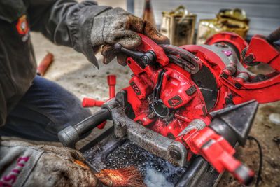 Close-up of man working at machine