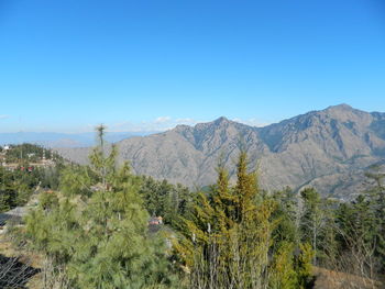 Scenic view of mountains against clear blue sky