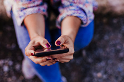 Midsection of woman using mobile phone