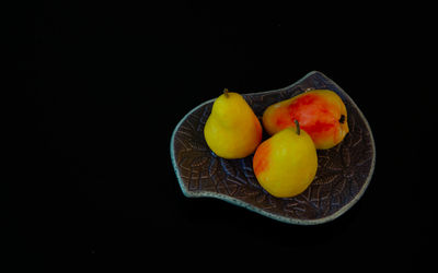 High angle view of orange fruits on table against black background