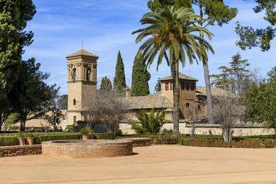 Palm trees and buildings against sky