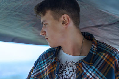 Close-up of young man looking away