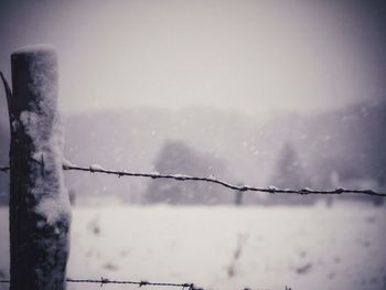 Close-up of snow against sky during winter