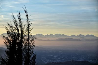 Scenic view of mountains against sky at sunset