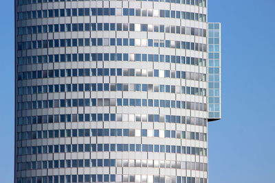 Low angle view of modern building against clear blue sky