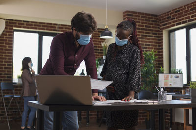 Business people wearing mask working at office