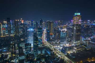 High angle view of illuminated buildings in city at night