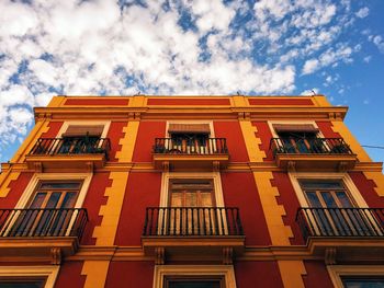 Low angle view of building against cloudy sky