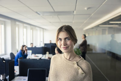 Portrait of team leader standing in office