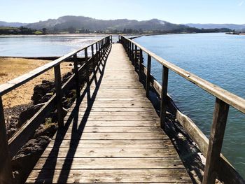 Pier over lake against sky