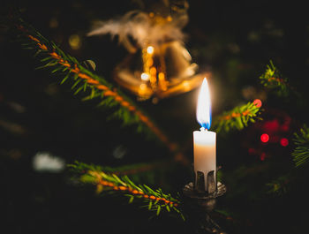 Close-up of illuminated candle on christmas tree