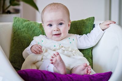 Cute baby girl lying on bed