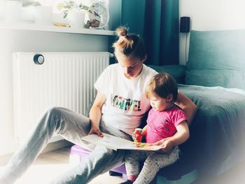 Women sitting on sofa at home
