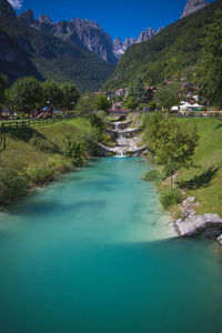 Scenic view of lake by mountain against sky