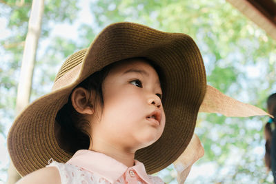 Close-up portrait of cute girl in hat