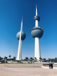 Low angle view of communications tower against blue sky