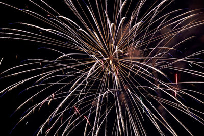 Low angle view of firework display at night