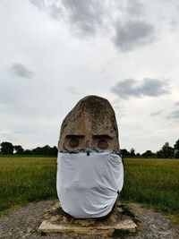 Rear view of man sitting on field