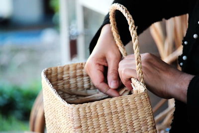 Close-up of woman holding wicker basket