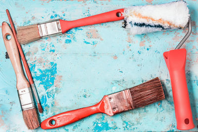 High angle view of paintbrushes on blue table