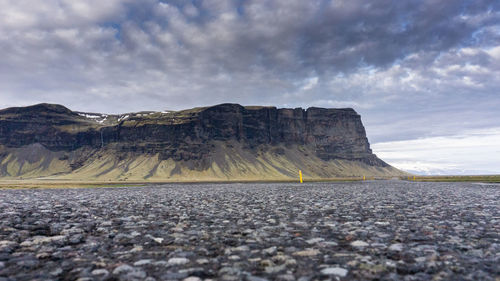 Surface level of rocky mountain against sky