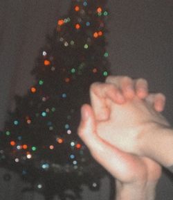 Defocused image of woman holding christmas tree