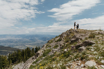 People on mountain against sky