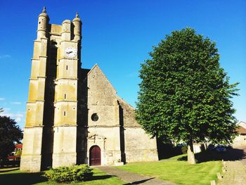 Low angle view of built structure against clear blue sky