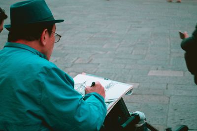 Man writing on book