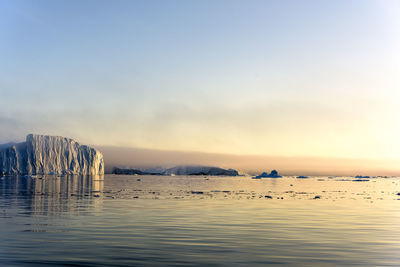 Scenic view of ilulissat disco bay against sky during sunset
