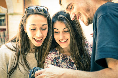 Happy young woman using smart phone