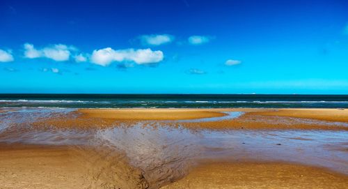 Scenic view of sea against blue sky