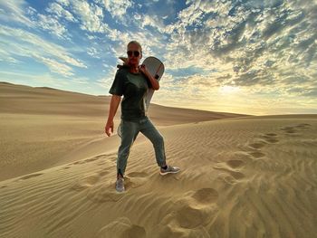 Full length of man on sand at beach against sky