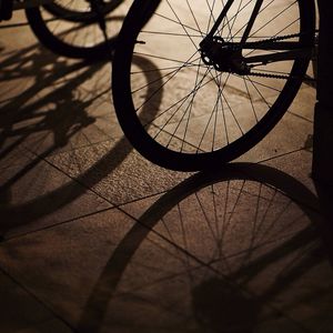 Cropped image of silhouette bicycle on sidewalk