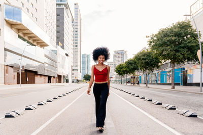 Portrait of woman standing on road