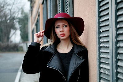 Portrait of beautiful young woman wearing hat