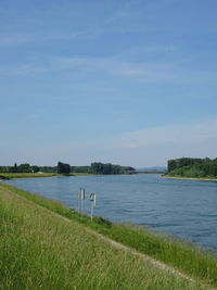 Scenic view of lake against blue sky