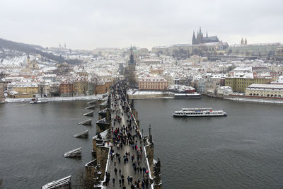 High angle view of people walking on bridge over river