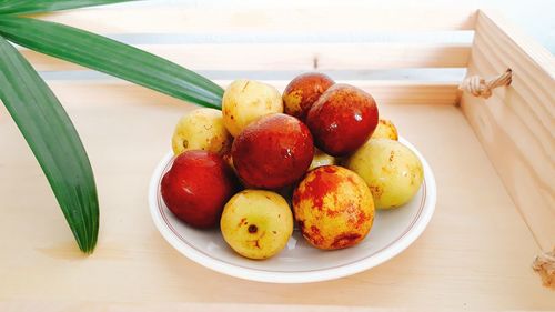 High angle view of fruits in plate on table