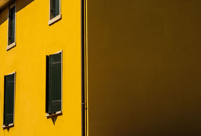 Close-up of yellow window on building