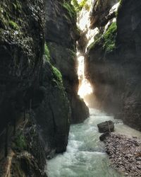 Scenic view of river flowing through cave