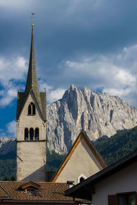 Low angle view of church against cloudy sky