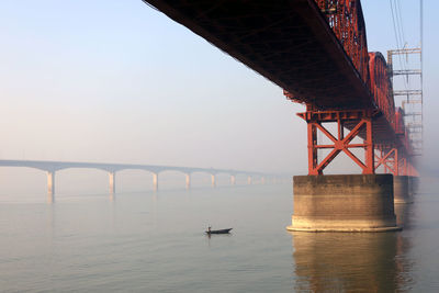 Bridge over sea against sky