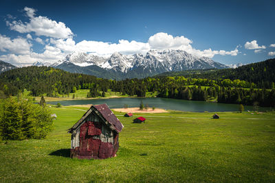 Scenic view of house and mountains against sky